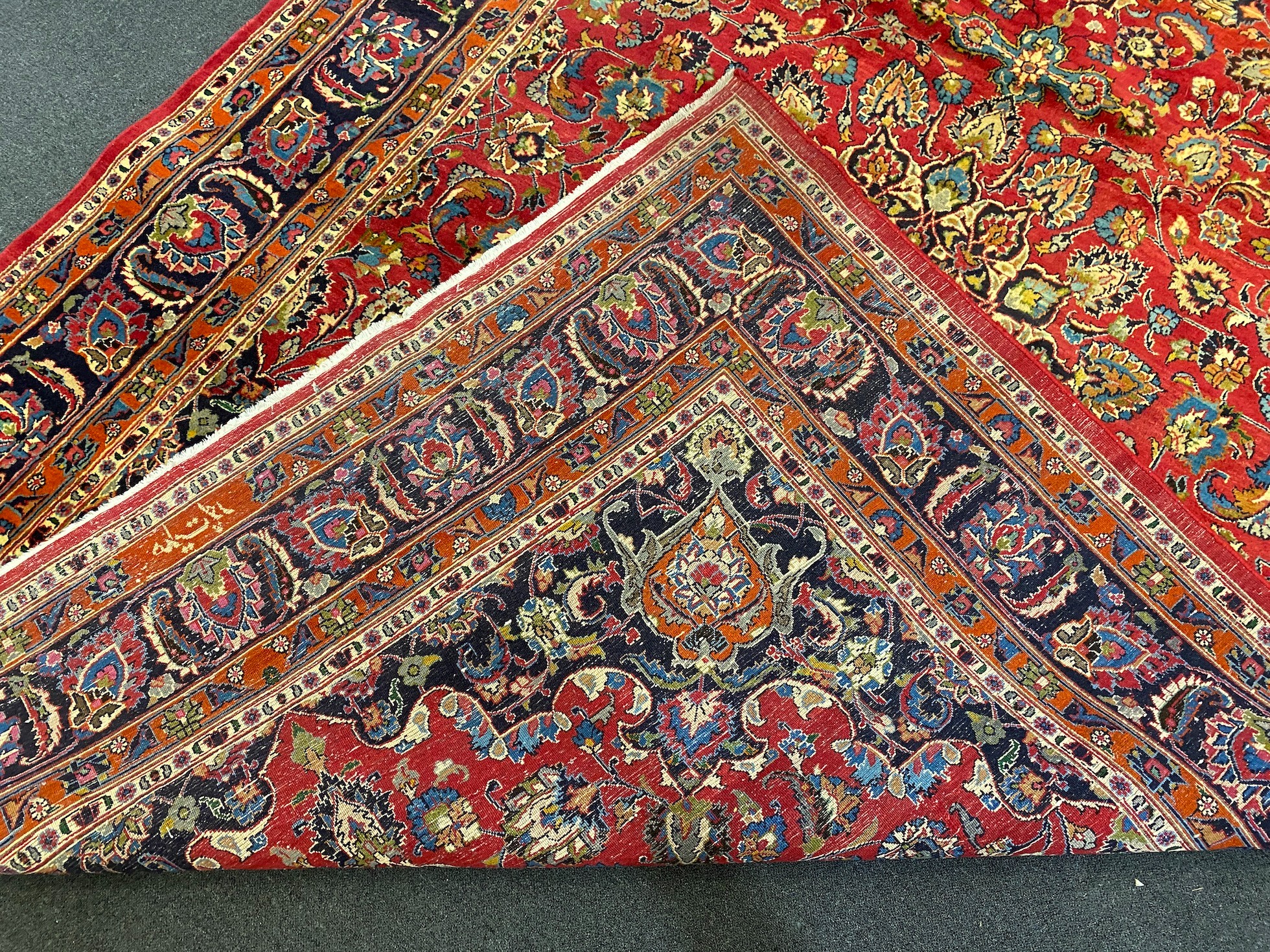 A Kashan claret ground carpet, 375cm x 250cm